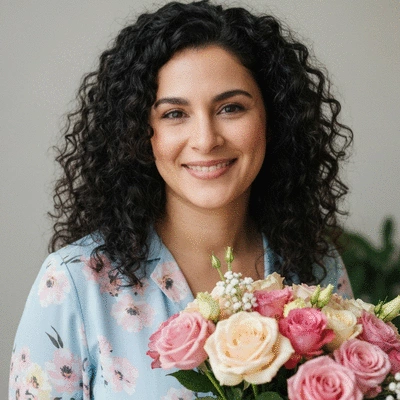 Close-up of hands arranging a personalized floral bouquet